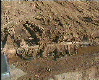 another driveway with soil in gutter.